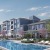 a swimming pool in front of a large building